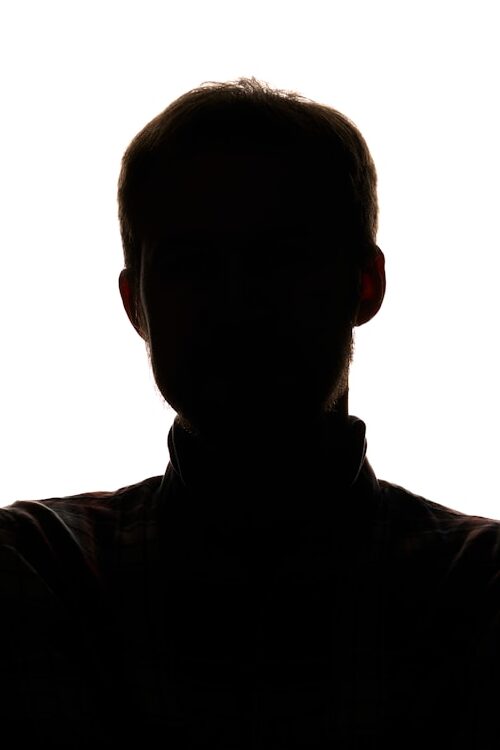 a silhouette of a man with his arms crossed